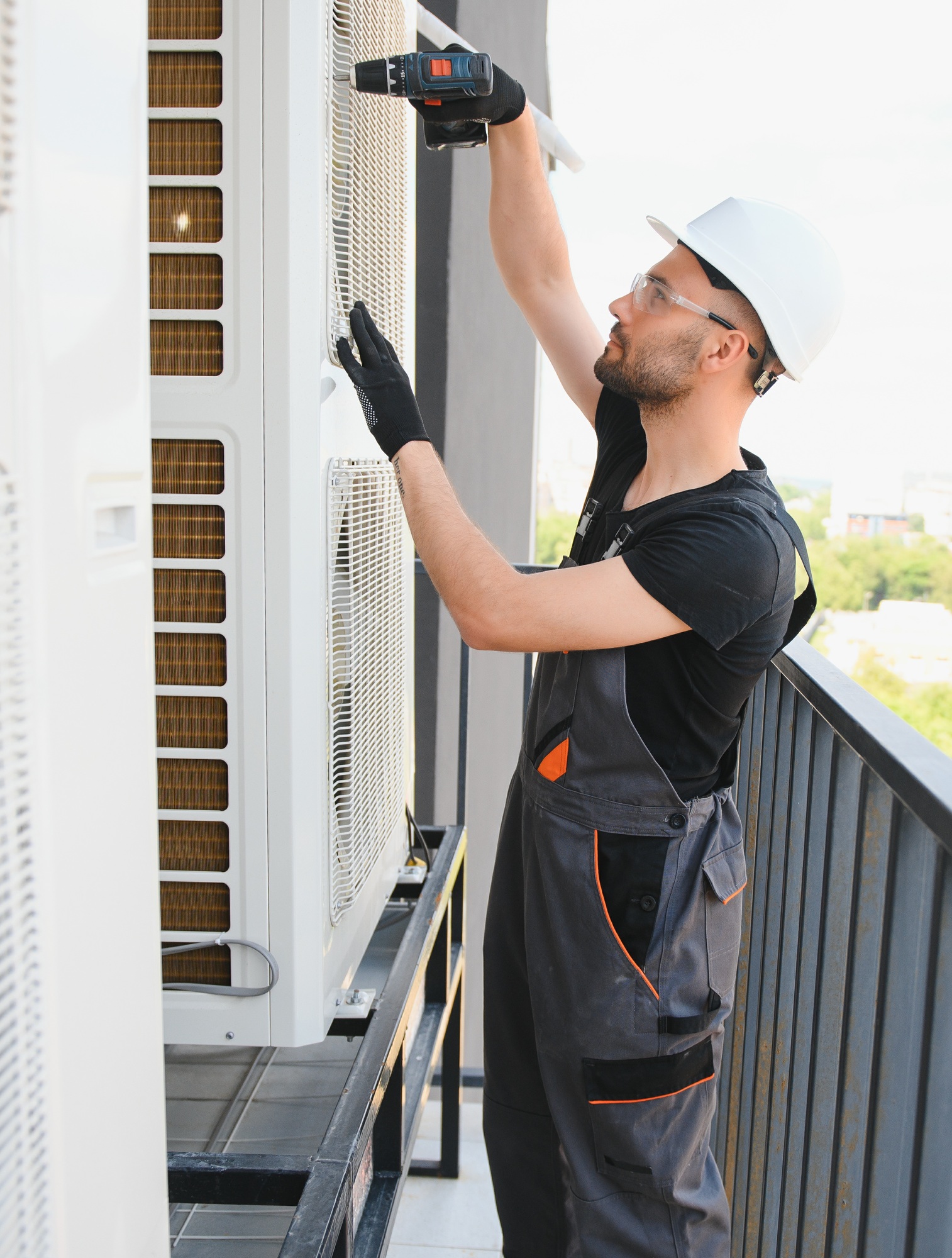 technician working on air conditioning or heat pump outdoor unit. HVAC service